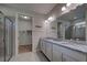 Double vanity bathroom with granite countertop and walk-in shower at 11976 Blazing Star Dr, Venice, FL 34293