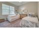 Two twin beds, nightstands, and window coverings in a bright bedroom at 11976 Blazing Star Dr, Venice, FL 34293