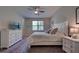 Main bedroom with a queen bed, dresser, and large window at 11976 Blazing Star Dr, Venice, FL 34293