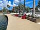 Relaxing boardwalk with red Adirondack chairs overlooking the water at 11976 Blazing Star Dr, Venice, FL 34293