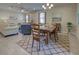 Dining room with wooden table and chairs, and view into living room at 11976 Blazing Star Dr, Venice, FL 34293