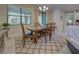 Charming dining room with wooden table and access to backyard at 11976 Blazing Star Dr, Venice, FL 34293