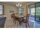 Bright dining area features a wooden table and stylish rug at 11976 Blazing Star Dr, Venice, FL 34293