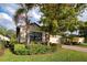 Landscaped home exterior showcasing a lush lawn and mature trees at 11976 Blazing Star Dr, Venice, FL 34293