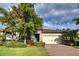 Attractive house exterior with a well-manicured lawn and a paved driveway at 11976 Blazing Star Dr, Venice, FL 34293
