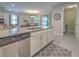 Kitchen island with granite countertop, sink, and dishwasher at 11976 Blazing Star Dr, Venice, FL 34293