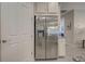 Stainless steel refrigerator in kitchen with granite countertop and white cabinets at 11976 Blazing Star Dr, Venice, FL 34293