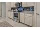 Clean kitchen features white cabinets and stainless steel appliances at 11976 Blazing Star Dr, Venice, FL 34293