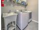 Laundry room with washer, dryer, and utility sink at 11976 Blazing Star Dr, Venice, FL 34293