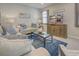 Bright living room features comfy seating, a large TV, and stylish decor at 11976 Blazing Star Dr, Venice, FL 34293