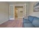 Home office with a couch and French doors leading to a hallway at 11976 Blazing Star Dr, Venice, FL 34293