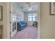 Home office with a couch, desk, and French doors at 11976 Blazing Star Dr, Venice, FL 34293