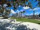 playground with rope features, artificial turf, and trees at 11976 Blazing Star Dr, Venice, FL 34293