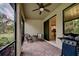 Relaxing screened patio with brick pavers, wicker furniture, and grill at 11976 Blazing Star Dr, Venice, FL 34293