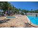 Community pool with lounge chairs and playground at 140 Hunter Lake Dr # G, Oldsmar, FL 34677