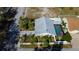 Aerial view of the home shows fenced yard, landscaping and screened pool at 1612 Sunset Dr, Tarpon Springs, FL 34689