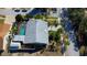 Aerial view of the house shows mature landscaping, fenced yard, and screened pool at 1612 Sunset Dr, Tarpon Springs, FL 34689