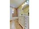 Bathroom features a shower, round mirror, vanity with marble countertop and tile floor at 1612 Sunset Dr, Tarpon Springs, FL 34689