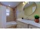 Bathroom with marble vanity and large mirror at 1612 Sunset Dr, Tarpon Springs, FL 34689