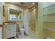 Bathroom with built-in shelving and a shower/tub combo at 1612 Sunset Dr, Tarpon Springs, FL 34689