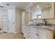 Elegant bathroom with double vanity, marble countertop and crystal lighting at 1612 Sunset Dr, Tarpon Springs, FL 34689