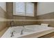 Luxurious bathroom with a large corner soaking tub and elegant tile at 1612 Sunset Dr, Tarpon Springs, FL 34689