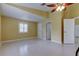 Bright bedroom with tile floors, a ceiling fan, and access to bathroom at 1612 Sunset Dr, Tarpon Springs, FL 34689