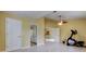 Large bedroom with tile floors, ceiling fan and exercise equipment at 1612 Sunset Dr, Tarpon Springs, FL 34689