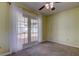 Bedroom with carpet, ceiling fan and French doors leading to the deck and pool area at 1612 Sunset Dr, Tarpon Springs, FL 34689