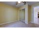 Bright bedroom with mirrored closet doors and neutral carpeting at 1612 Sunset Dr, Tarpon Springs, FL 34689
