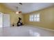 Spacious bedroom with tile floors, ceiling fan and access to bathroom at 1612 Sunset Dr, Tarpon Springs, FL 34689