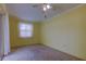 Bedroom with carpet flooring, a ceiling fan and a window with blinds and curtains at 1612 Sunset Dr, Tarpon Springs, FL 34689