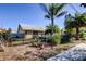 Single story home with tropical landscaping, and black metal fence at 1612 Sunset Dr, Tarpon Springs, FL 34689