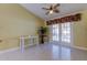 Gathering room with tiled floors, sliding doors to pool area, and ceiling fan at 1612 Sunset Dr, Tarpon Springs, FL 34689