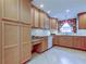Kitchen with light wood cabinets, granite countertops, and ample storage at 1612 Sunset Dr, Tarpon Springs, FL 34689