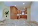 Kitchen features granite countertops, wood cabinets, and a view into the living area at 1612 Sunset Dr, Tarpon Springs, FL 34689