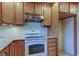 Kitchen boasts wood cabinets, granite countertops, and a white electric range at 1612 Sunset Dr, Tarpon Springs, FL 34689