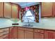 Kitchen features light wood cabinets, granite countertops, and a window at 1612 Sunset Dr, Tarpon Springs, FL 34689