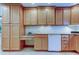 Kitchen boasts light wood cabinets, granite counters, and a dishwasher at 1612 Sunset Dr, Tarpon Springs, FL 34689