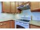 Bright kitchen with wood cabinets, granite counters, and stainless steel appliances at 1612 Sunset Dr, Tarpon Springs, FL 34689