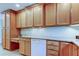 Kitchen features ample wood cabinetry, granite countertops, and built-in desk area at 1612 Sunset Dr, Tarpon Springs, FL 34689