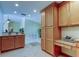 Eat-in kitchen with wood cabinets, granite counters, and views to adjacent living area at 1612 Sunset Dr, Tarpon Springs, FL 34689
