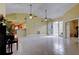 Large living area with tile floors, high ceilings, and access to a patio at 1612 Sunset Dr, Tarpon Springs, FL 34689