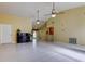 Open living room with tile floors and views into kitchen and hallway at 1612 Sunset Dr, Tarpon Springs, FL 34689