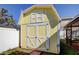 Backyard features a yellow storage shed with white doors and a view of the screened in pool at 1612 Sunset Dr, Tarpon Springs, FL 34689