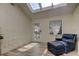 Sunroom with skylights, leather chair, and French doors leading outside at 1612 Sunset Dr, Tarpon Springs, FL 34689
