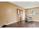 Living room with hardwood floors, a recliner, and double doors at 1704 W Humphrey St, Tampa, FL 33604