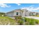 Exterior view of a house with gray siding and a two car garage at 18369 Cropside Trl, Lakewood Ranch, FL 34211