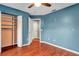 Blue bedroom with hardwood floors and walk-in closet at 18817 Avenue Biarritz, Lutz, FL 33558