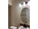 Bathroom with updated vanity, oval mirror, and tiled shower/tub at 21038 Voyager Blvd # 4, Land O Lakes, FL 34638